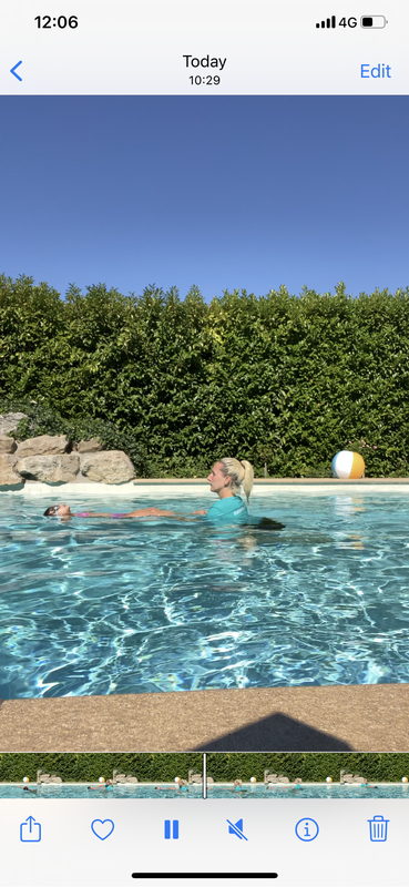 Swimming instructor teaching one-on-one lessons to a child in a residential pool | Personalized swimming instruction for children from 12 months old.